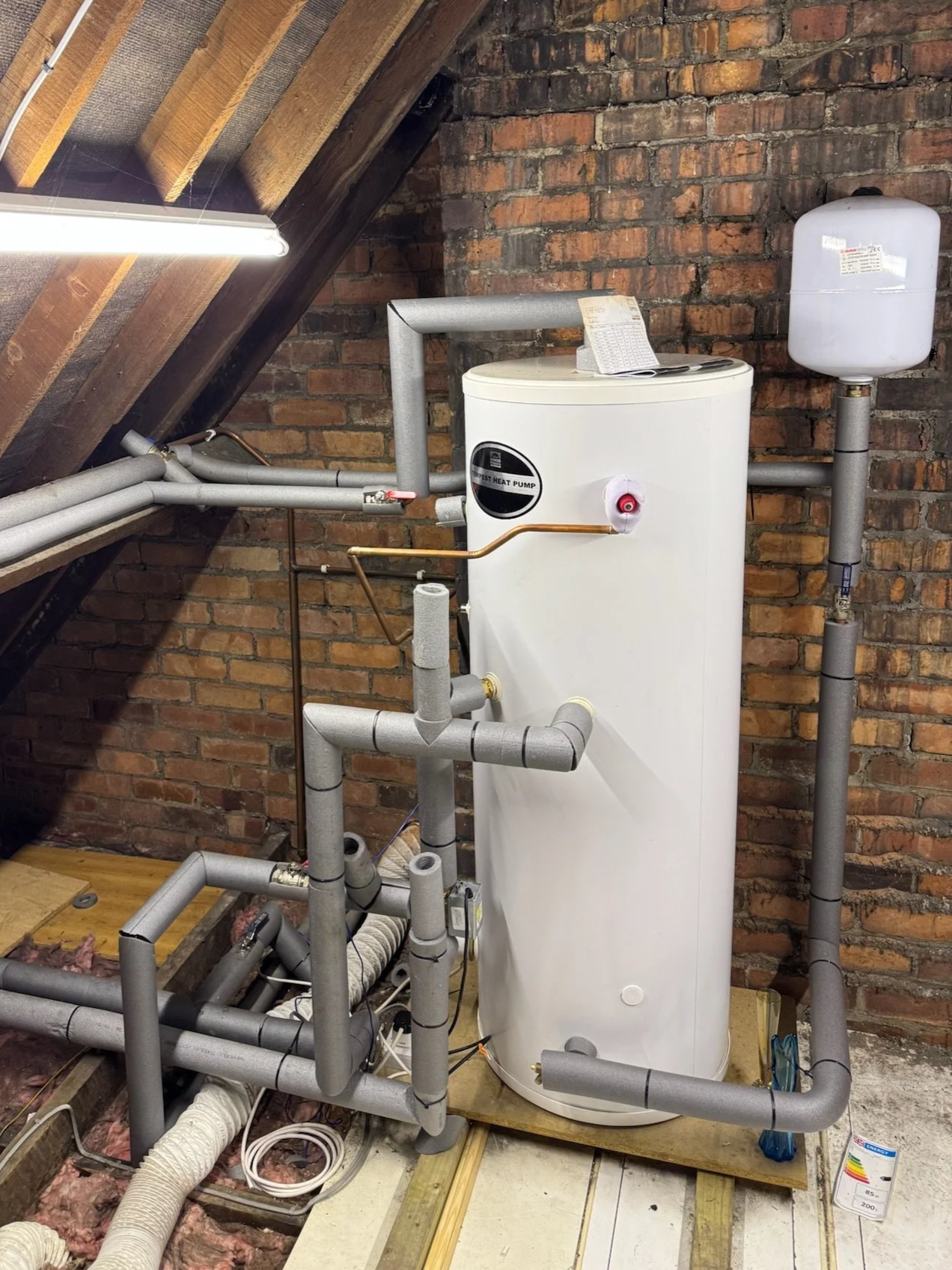 Heat pump cylinder installed in a loft